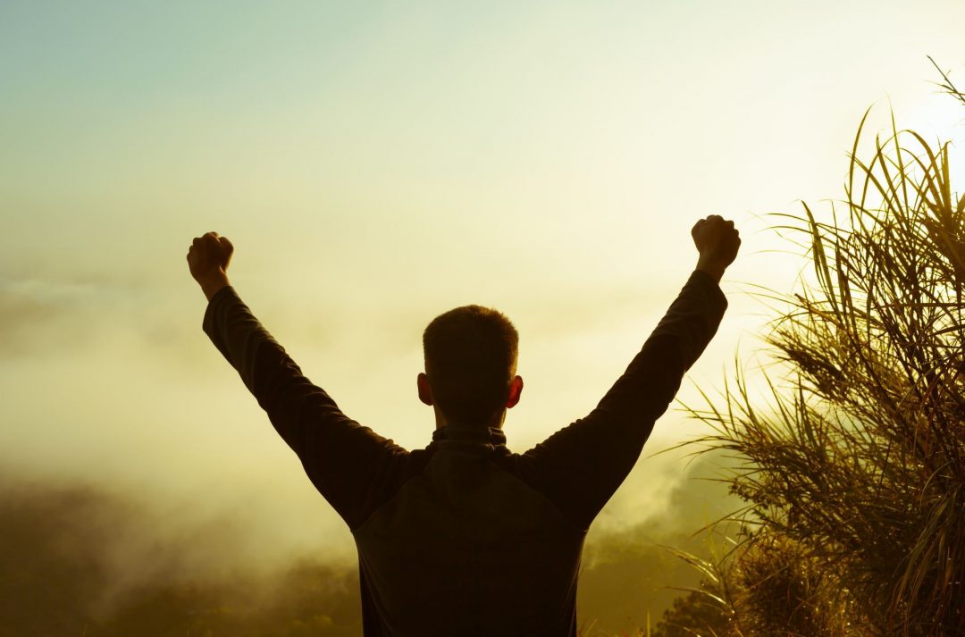 Man raising hands in air silhouette